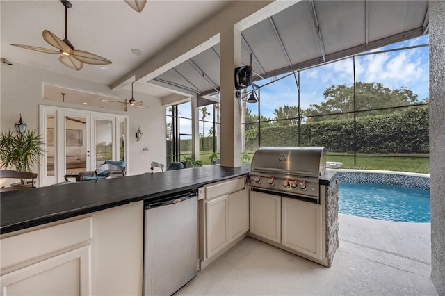 5025 Down Point Ln, Windermere, FL 34786 - kitchen with refrigerator, ceiling fan, dark countertops, and a sunroom