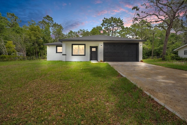 2071 W Doral Ct, Citrus Springs, FL 34434 - view of front of house featuring driveway, an attached garage, stucco siding, and a front lawn