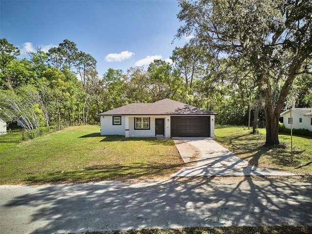 2071 W Doral Ct, Citrus Springs, FL 34434 - view of front of home featuring an attached garage, driveway, and a front yard