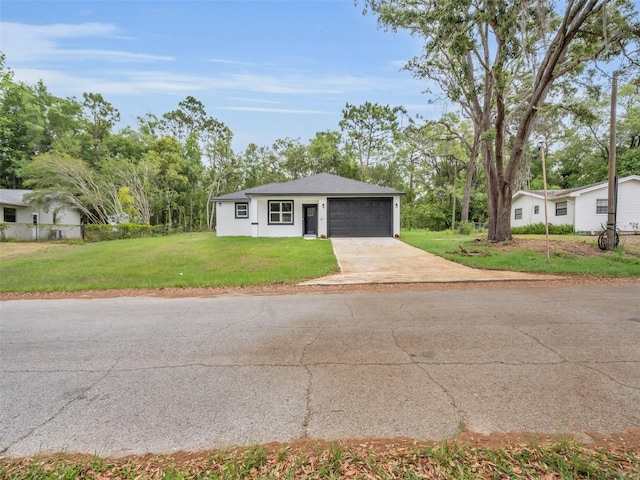 2071 W Doral Ct, Citrus Springs, FL 34434 - view of front facade featuring a front lawn, driveway, and a garage