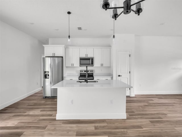 2071 W Doral Ct, Citrus Springs, FL 34434 - kitchen featuring appliances with stainless steel finishes, an island with sink, white cabinetry, and baseboards