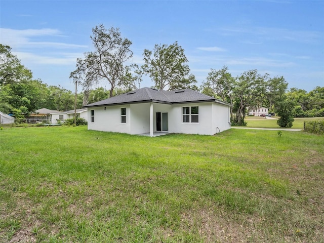 2071 W Doral Ct, Citrus Springs, FL 34434 - back of house with stucco siding and a yard
