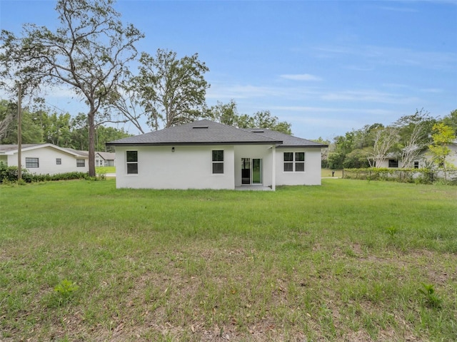 2071 W Doral Ct, Citrus Springs, FL 34434 - back of property featuring stucco siding, a lawn, and roof with shingles