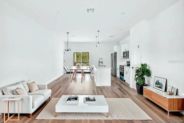 2071 W Doral Ct, Citrus Springs, FL 34434 - living room with light wood finished floors and baseboards