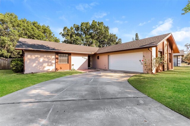 4265 Old Colony Rd, Mulberry, FL 33860 - single story home with an attached garage, a front yard, concrete driveway, and stucco siding