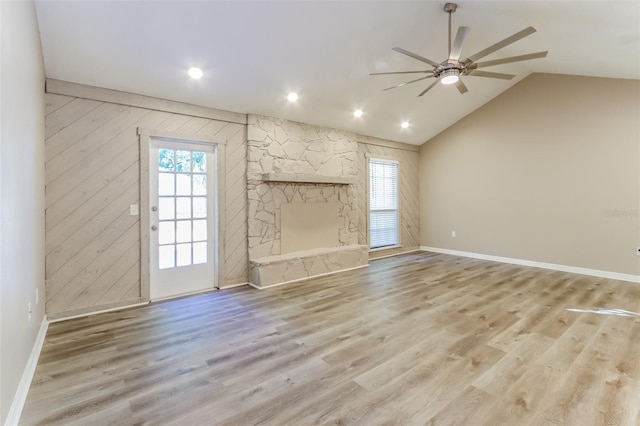 4265 Old Colony Rd, Mulberry, FL 33860 - unfurnished living room with ceiling fan, a fireplace, light wood-style floors, vaulted ceiling, and baseboards