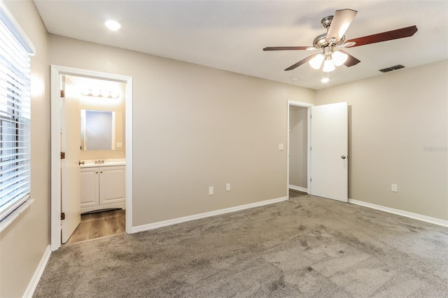 4265 Old Colony Rd, Mulberry, FL 33860 - unfurnished bedroom with carpet floors, multiple windows, ensuite bathroom, baseboards, and recessed lighting