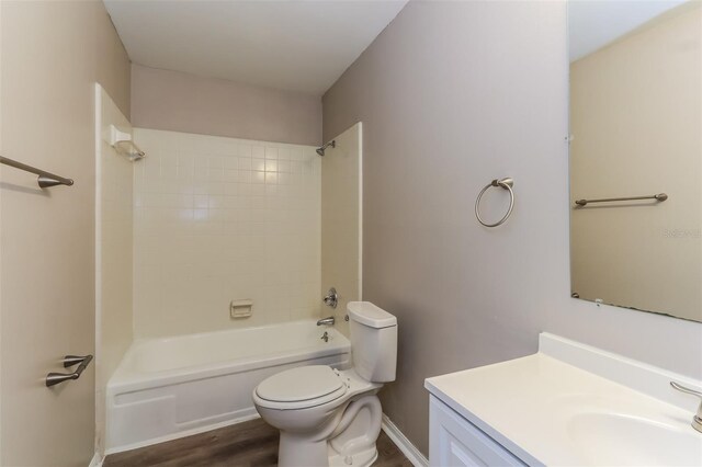 4265 Old Colony Rd, Mulberry, FL 33860 - full bathroom with toilet, wood finished floors, vanity, and shower / bath combination