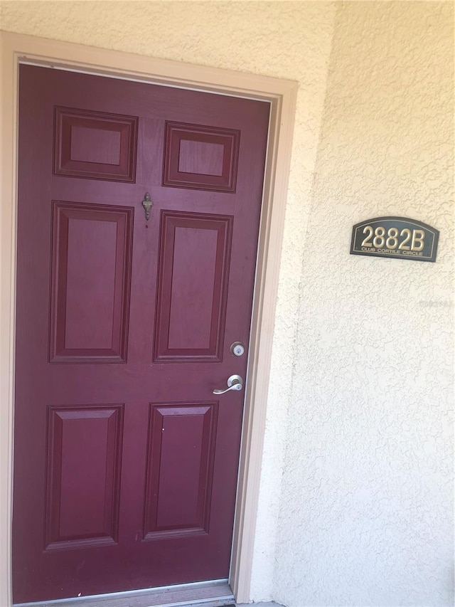 2882 Club Cortile Cir Unit B, Kissimmee, FL 34746 - property entrance featuring stucco siding