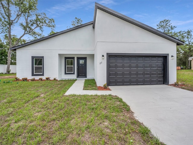 contemporary house featuring an attached garage, stucco siding, driveway, and a front lawn