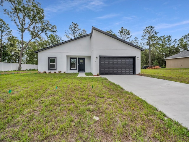 contemporary house with an attached garage, driveway, and stucco siding