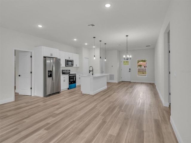 kitchen featuring stainless steel appliances, recessed lighting, open floor plan, white cabinetry, and baseboards