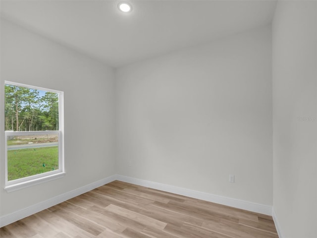 spare room with light wood-style floors, baseboards, and recessed lighting