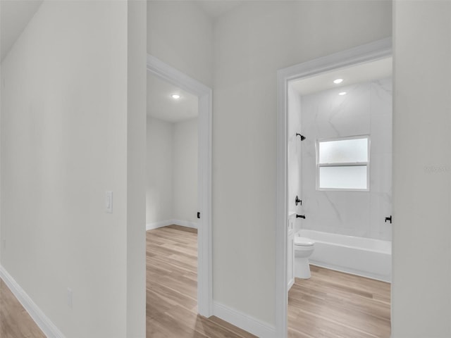 hallway featuring wood finished floors, recessed lighting, and baseboards