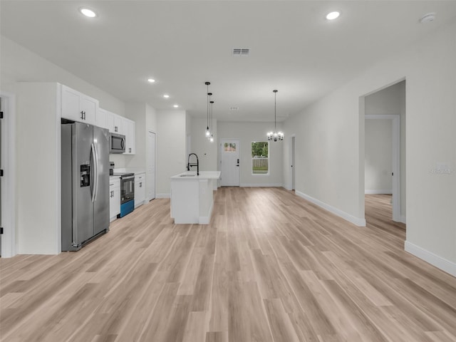 kitchen featuring stainless steel appliances, white cabinets, recessed lighting, light wood-type flooring, and light countertops