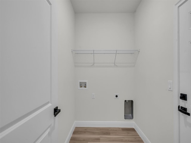 laundry room with hookup for an electric dryer, baseboards, washer hookup, and light wood finished floors