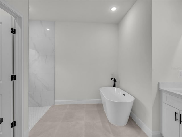 bathroom featuring a soaking tub, vanity, walk in shower, recessed lighting, and baseboards