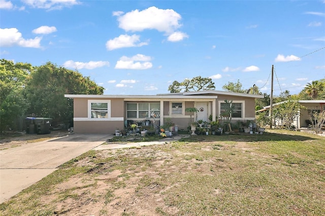 1508 Roger Babson Rd, Orlando, FL 32808 - view of front facade with stucco siding and a front yard
