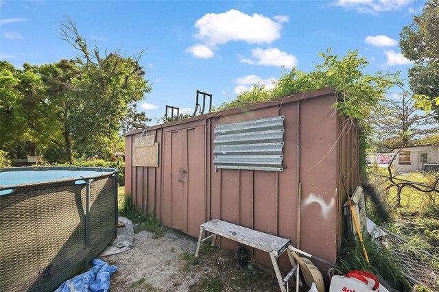 1508 Roger Babson Rd, Orlando, FL 32808 - view of home's exterior with an outdoor pool, board and batten siding, and fence