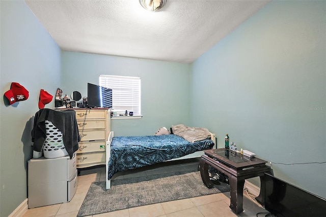 1508 Roger Babson Rd, Orlando, FL 32808 - tiled bedroom featuring a textured ceiling and baseboards