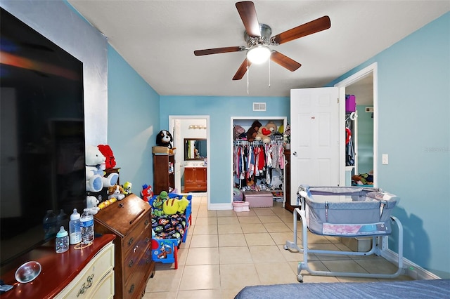 1508 Roger Babson Rd, Orlando, FL 32808 - bedroom featuring tile patterned flooring, baseboards, a ceiling fan, connected bathroom, and a closet