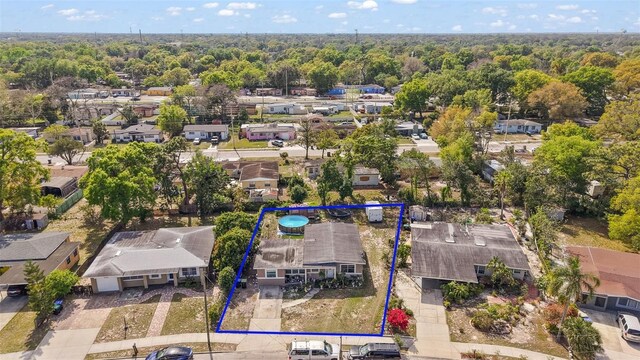 1508 Roger Babson Rd, Orlando, FL 32808 - aerial perspective of suburban area with a forest and property boundaries highlighted