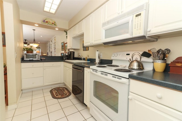 474 Windmeadows St Unit 0, Altamonte Springs, FL 32701 - kitchen featuring white appliances, dark countertops, a sink, light tile patterned flooring, and white cabinetry