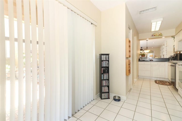 474 Windmeadows St Unit 0, Altamonte Springs, FL 32701 - hall with light tile patterned floors, healthy amount of natural light, and baseboards
