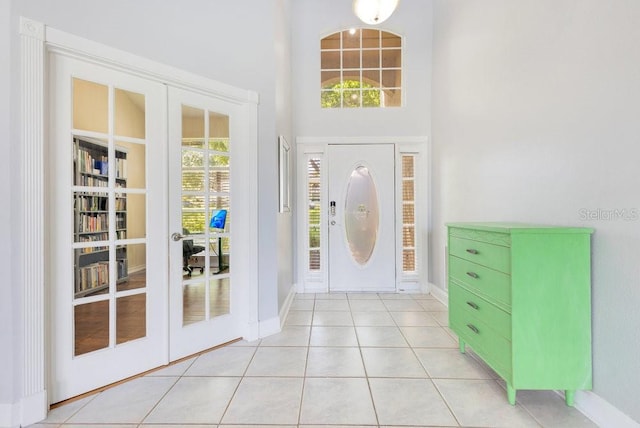 1837 Sweetwater W Cir, Apopka, FL 32712 - foyer entrance with baseboards, french doors, a high ceiling, and light tile patterned floors