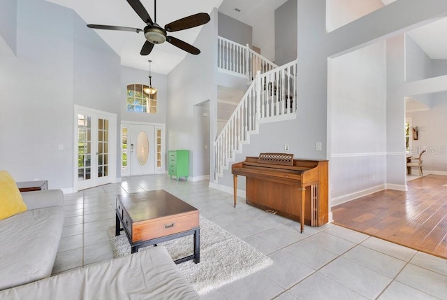 1837 Sweetwater W Cir, Apopka, FL 32712 - tiled living area featuring high vaulted ceiling, ceiling fan, baseboards, stairway, and french doors