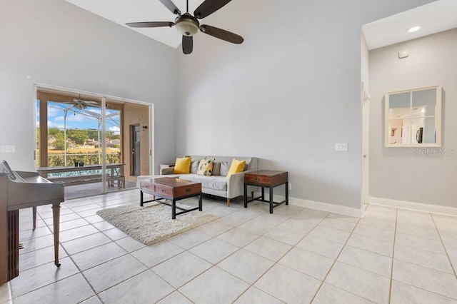 1837 Sweetwater W Cir, Apopka, FL 32712 - living room with a high ceiling, a ceiling fan, light tile patterned floors, and baseboards