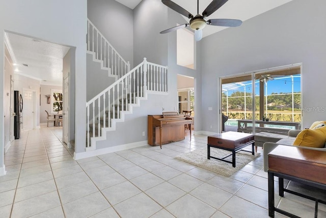 1837 Sweetwater W Cir, Apopka, FL 32712 - living room featuring a high ceiling, light tile patterned flooring, a ceiling fan, baseboards, and stairway