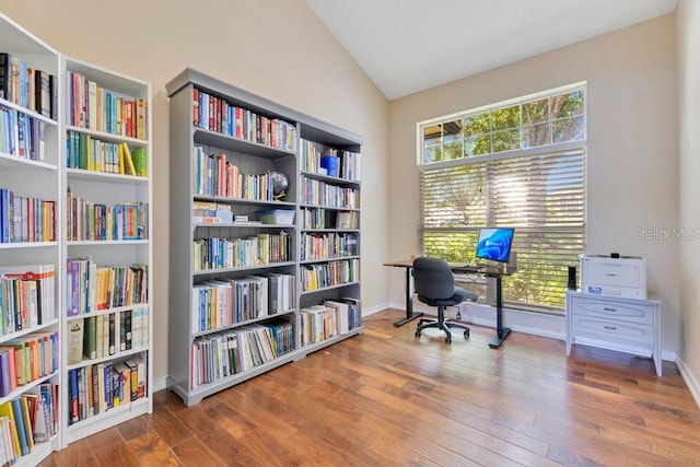 1837 Sweetwater W Cir, Apopka, FL 32712 - office featuring bookshelves, lofted ceiling, wood finished floors, healthy amount of natural light, and baseboards