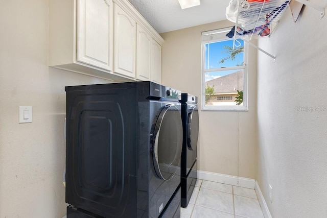 1837 Sweetwater W Cir, Apopka, FL 32712 - laundry room with washer and dryer, cabinet space, light tile patterned floors, and baseboards