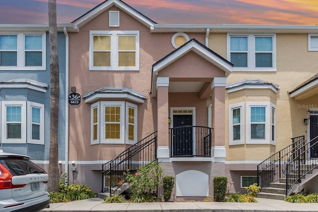 6611 Time Square Ave Unit 103, Orlando, FL 32835 - view of property featuring stairs and stucco siding