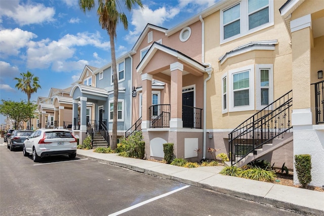 6611 Time Square Ave Unit 103, Orlando, FL 32835 - view of front of house featuring stucco siding, stairway, and a residential view