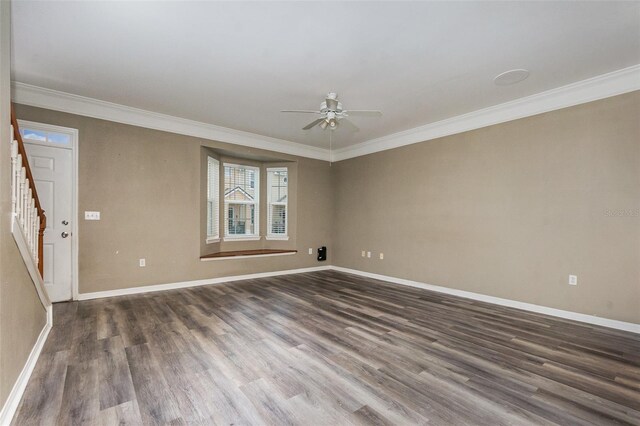 6611 Time Square Ave Unit 103, Orlando, FL 32835 - empty room featuring dark wood-type flooring, ceiling fan, baseboards, crown molding, and stairway