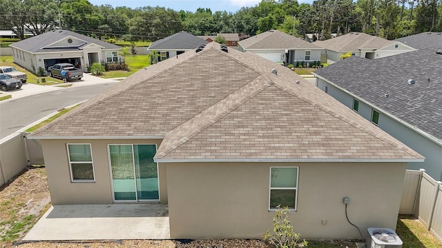 7054 Cruz Ct, Lakeland, FL 33813 - back of house featuring roof with shingles, stucco siding, and a patio