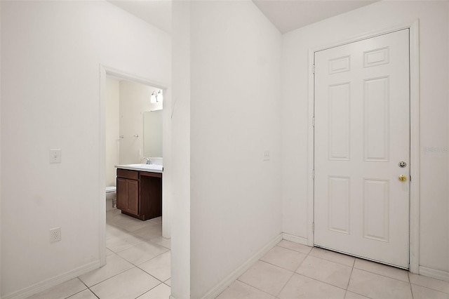 7054 Cruz Ct, Lakeland, FL 33813 - hallway featuring baseboards, light tile patterned floors, and a sink