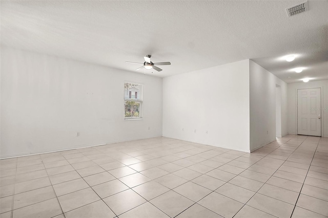 7054 Cruz Ct, Lakeland, FL 33813 - unfurnished room with a ceiling fan, light tile patterned floors, and a textured ceiling