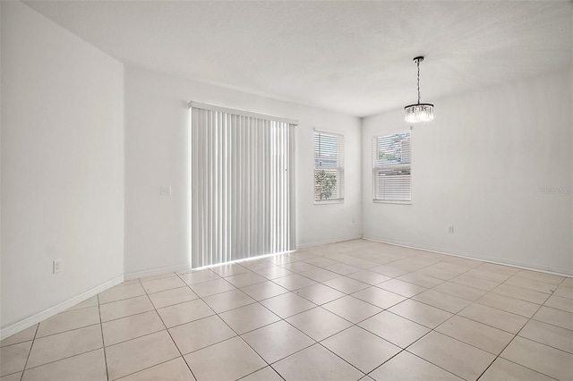 7054 Cruz Ct, Lakeland, FL 33813 - empty room featuring light tile patterned floors and a chandelier