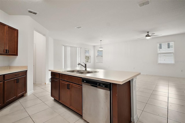 7054 Cruz Ct, Lakeland, FL 33813 - kitchen with stainless steel dishwasher, a sink, light tile patterned floors, light countertops, and a ceiling fan