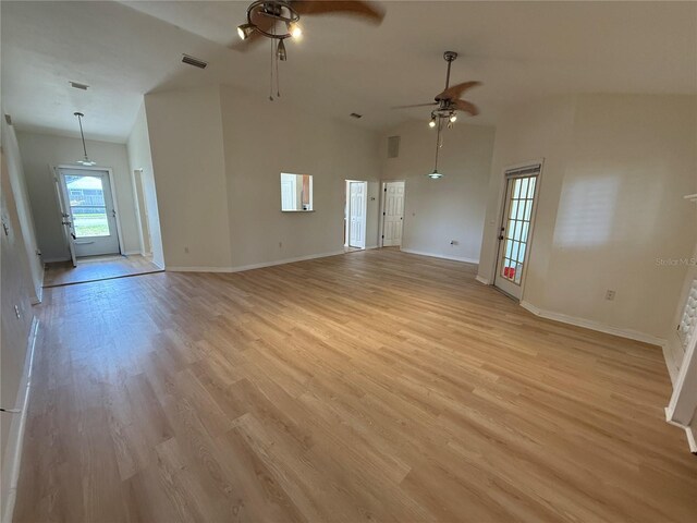 unfurnished living room with a ceiling fan, light wood finished floors, baseboards, and high vaulted ceiling