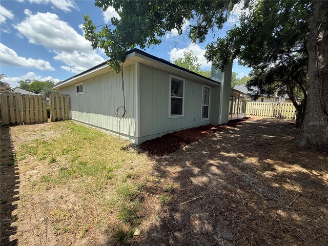 view of side of home with fence