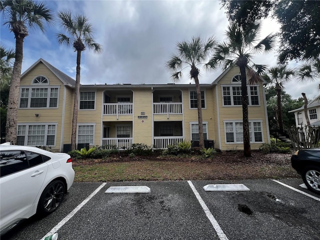 1089 S Hiawassee Rd Unit 323, Orlando, FL 32835 - view of building exterior featuring uncovered parking