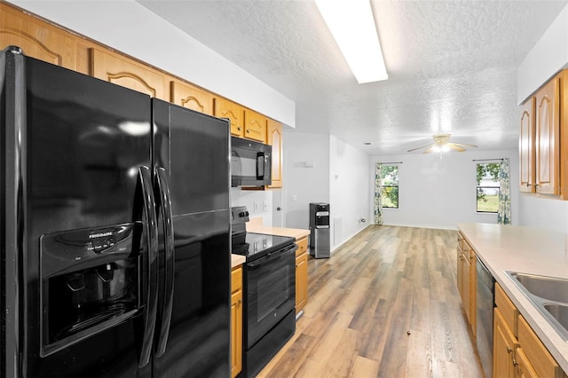 1106 Alpine Ave NW, Palm Bay, FL 32907 - kitchen featuring black appliances, a textured ceiling, light countertops, light wood-style floors, and a ceiling fan