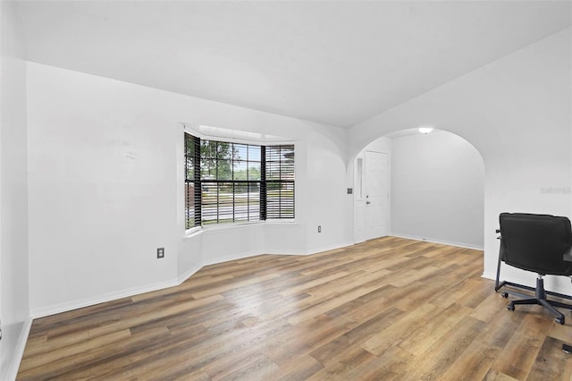 1106 Alpine Ave NW, Palm Bay, FL 32907 - unfurnished office featuring wood finished floors, baseboards, and arched walkways