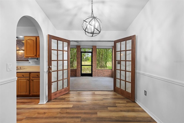 1106 Alpine Ave NW, Palm Bay, FL 32907 - entryway with french doors, wood finished floors, a chandelier, and baseboards