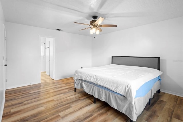1106 Alpine Ave NW, Palm Bay, FL 32907 - bedroom with wood finished floors, baseboards, and ceiling fan