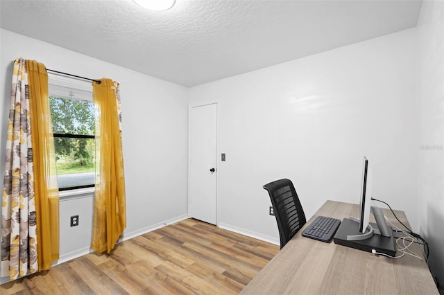 1106 Alpine Ave NW, Palm Bay, FL 32907 - home office featuring wood finished floors, a textured ceiling, and baseboards